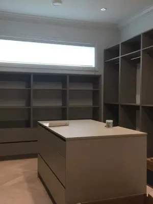 Built-in storage room with open shelving and a central island