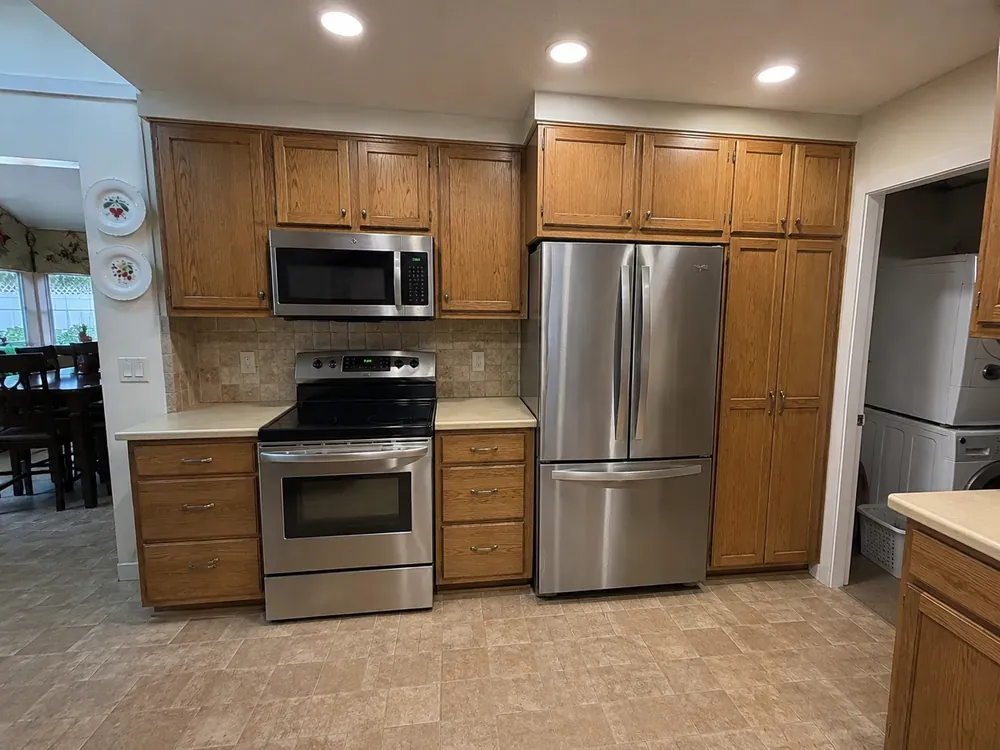 White cabinetry and quartz counters in Langley, before